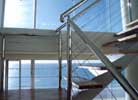 Stairwell decked out in stainless steel balustrading with nautical wire