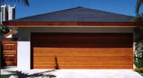 Wide cedar garage door and ornate front gate